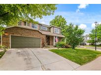 Charming two-story home with brick and siding, well-maintained lawn, and an attached two-car garage at 10284 Royal Eagle St, Highlands Ranch, CO 80129
