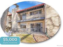 Two-story brick home featuring charming balconies with wrought iron railings and a well-maintained front yard at 2665 S Sheridan Ct, Lakewood, CO 80227