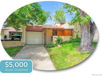 Charming brick townhome with mature trees, covered porch, and well-manicured lawn and including a buyer incentive at 2665 S Sheridan Ct, Lakewood, CO 80227