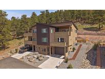 Modern townhome with a two-car garage and beautiful landscaping at 726 Dreamcatcher Ln, Evergreen, CO 80439