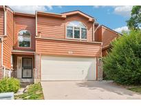 Charming home featuring a two-car garage, a brick trim, unique arch windows and mature landscaping at 108 Ward Ct, Lakewood, CO 80228