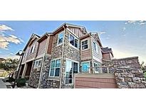 Beautiful townhome with stone and siding exterior, showcasing architectural details and curb appeal at 23525 E Platte Dr # 10B, Aurora, CO 80016