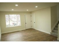 Bright, freshly painted living room featuring wood floors and lots of natural light at 3825 E 123Rd Ave, Thornton, CO 80241