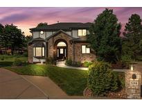 Stunning two-story brick home featuring a manicured lawn and mature landscaping, perfect for curb appeal at 5284 Taft Ct, Arvada, CO 80002