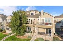 Beautiful tan townhome featuring multiple balconies and stone accents at 11250 Florence St # 5C, Commerce City, CO 80640