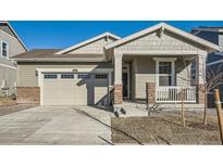 Exterior of charming craftsman style home with two-car garage and front porch at 4847 Astor Pl, Brighton, CO 80601