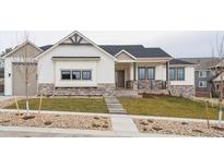 Charming single-story home featuring stone accents, black trim windows, and a well-manicured front yard at 1361 Art Dr, Berthoud, CO 80513