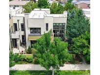 Modern exterior with a flat roof, many windows and lush landscaping at 8041 E 29Th Ave, Denver, CO 80238