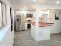 Modern kitchen features stainless steel appliances and wood countertops at 1445 Yosemite St # 12, Denver, CO 80220