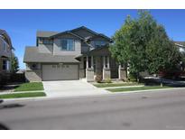 Charming two-story home featuring a two-car garage, covered porch, and well-maintained landscaping at 11811 Lewiston St, Commerce City, CO 80022