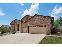 Charming home featuring a stone facade, two-car garage, and an inviting driveway at 15616 Soo Line Way, Monument, CO 80132