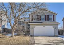 Two-story house with attached garage, light beige siding, and burgundy shutters at 16641 Martingale Dr, Parker, CO 80134