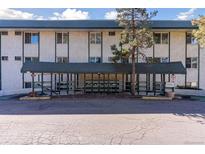 Front view of the building with a covered entrance featuring an awning and landscaped surroundings at 8826 E Florida Ave # G11, Denver, CO 80247
