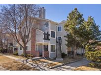 Well-maintained condo exterior with brick accents and mature trees at 5550 W 80Th Pl # 23, Arvada, CO 80003