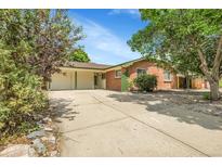 Charming single-story brick home with a spacious driveway and a two-car garage at 797 W Briarwood Ave, Littleton, CO 80120