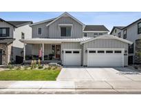 Charming two-story home with a well-manicured lawn and a spacious two car attached garage at 11053 Bright Sky Cir, Littleton, CO 80125