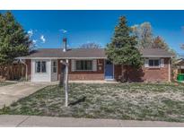 Charming brick home featuring a well-maintained lawn and inviting curb appeal at 8325 Elati St, Denver, CO 80221