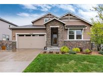 Charming two-story home with stone accents, manicured lawn, and a two-car garage at 16549 Prospect Ln, Broomfield, CO 80023