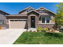 Charming single-Gathering home with a stone facade, manicured lawn, and an attached two-car garage at 16549 Prospect Ln, Broomfield, CO 80023