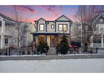 Two-story house with brick and siding exterior, a front porch, and a landscaped yard at 8056 E 35Th Ave, Denver, CO 80238