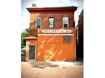Charming red brick two-story building featuring a 