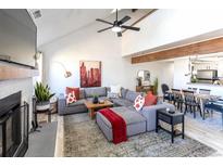 Bright living room featuring a sectional couch, fireplace, vaulted ceilings and an open layout at 10335 E Peakview Ave # B, Englewood, CO 80111