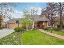 Charming brick home featuring a well-manicured lawn, brick walkway, and mature trees, perfect for curb appeal at 8424 E Otero Cir, Centennial, CO 80112