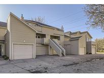 An exterior elevation shows a multi-unit residential home with beige siding and stairs to the units at 5075 Garrison St # 3, Wheat Ridge, CO 80033