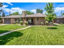 Charming brick home with a well-manicured lawn and inviting walkway at 2845 Hudson St, Denver, CO 80207