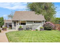 Charming single Gathering home showcasing a well-manicured lawn, mature trees and colorful flowers at 2595 S Irving St, Denver, CO 80219