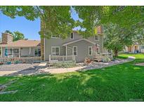 Charming home featuring a well-maintained front yard, a white picket fence, and an inviting porch at 8438 Everett Way # B, Arvada, CO 80005