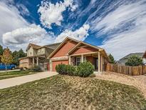 Charming single-Gathering home with a well-manicured lawn and welcoming curb appeal at 4118 Desert Ridge Cir, Castle Rock, CO 80108