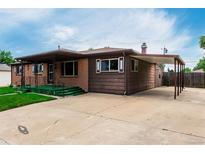 Charming single-story home featuring a brick facade, covered porch, and a convenient carport at 3334 W Grand Ave, Englewood, CO 80110