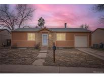 Charming single story home with neutral paint, stone accents and a neatly maintained front yard at 3937 S Truckee St, Aurora, CO 80013