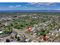 An aerial view of a charming neighborhood with mature trees and a mountain backdrop at 2401 W Jewell Ave, Denver, CO 80219
