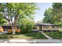 Charming brick ranch-style home with mature trees, a landscaped front yard, and a welcoming entrance at 1695 E Eastman Ave, Englewood, CO 80113