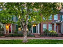 Charming two-story home with a well-maintained front yard and inviting green door at 8421 E 29Th Ave, Denver, CO 80238