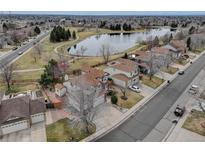 View of a home next to a peaceful lake in a quiet neighborhood at 18292 E Caspian Pl, Aurora, CO 80013