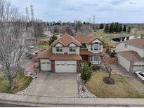 Charming two-story home with a well-manicured lawn, three-car garage, and beautiful landscaping at 18292 E Caspian Pl, Aurora, CO 80013