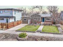 Charming single-story home with well-maintained lawn and inviting blue front door at 3640 York St, Denver, CO 80205