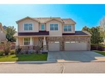 Beautiful two-story home with a three-car garage and manicured lawn on a sunny day at 15122 Fillmore Way, Thornton, CO 80602