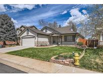 Charming single-Gathering home with manicured lawn and stone accents at 15901 W 66Th Pl, Arvada, CO 80007