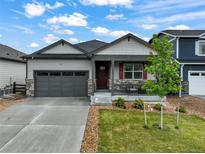 Charming single Gathering home with a well-manicured lawn, covered porch, and two car garage at 2130 Indian Balsam Dr, Monument, CO 80132