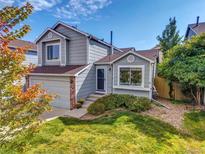 Charming two-story home with a well-manicured front yard and attached garage on a sunny day at 1462 Hyacinth Way, Superior, CO 80027