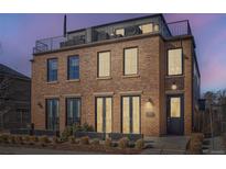 Charming brick townhouse with a rooftop deck, offering a blend of classic style and modern outdoor living at 4117 Quivas St, Denver, CO 80211