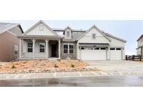 Charming home featuring a stone facade, covered porch, three-car garage and low maintenance landscaping at 3929 Treadway Pt, Castle Rock, CO 80108