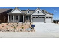 Charming single-Gathering home featuring a welcoming porch, stone accents, and a two-car garage at 3929 Treadway Pt, Castle Rock, CO 80108