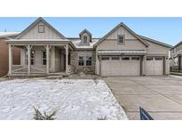 Charming home featuring stone accents, a covered porch, and a convenient two-car garage at 3929 Treadway Pt, Castle Rock, CO 80108