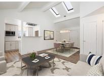 Open concept dining area with kitchen and vaulted ceiling at 1901 Clinton St, Aurora, CO 80010