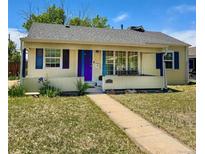 Charming single-story home features a cozy front porch swing, bright blue shutters and door, and a well-maintained lawn at 1901 Clinton St, Aurora, CO 80010